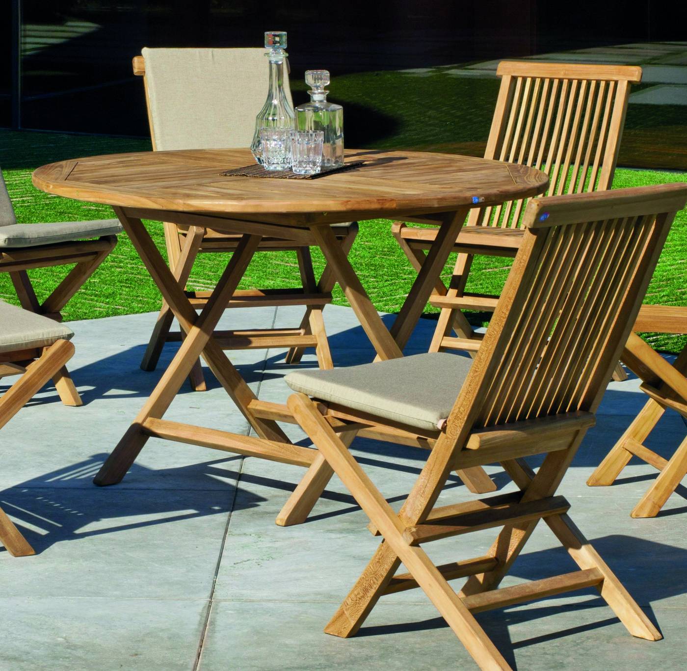 Conjunto Teka Seroni 100-4 - Conjunto de madera de teka: 1 mesa redonda plegable 100 cm. + 4 sillas con cojines asiento